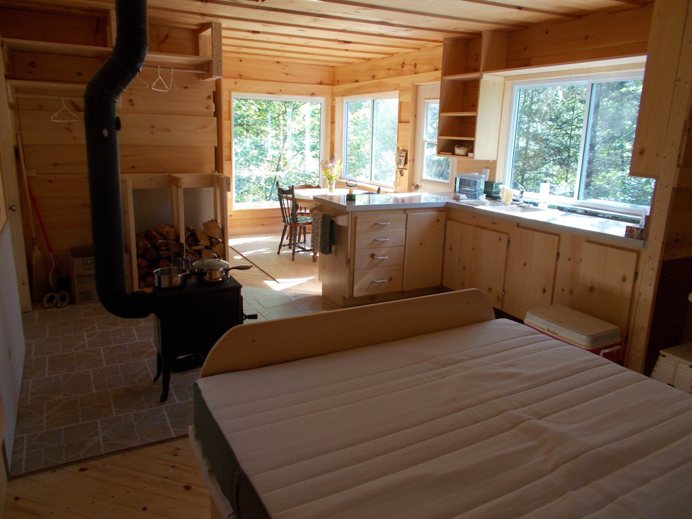 Wide view of inside rental cabin from beside bed